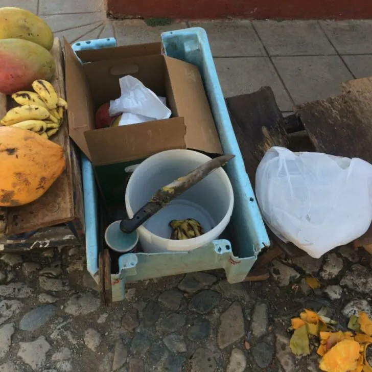 A makeshift fruit stand in Trinidad, Cuba, with mangoes and bananas