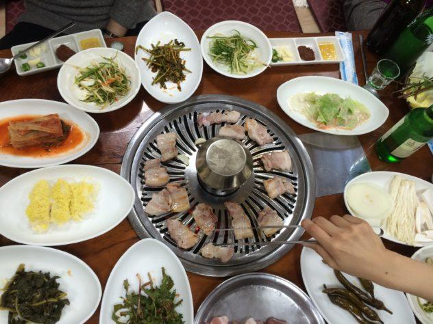 Korean Samgyupsal set including pork, meat, kimchi, and others.