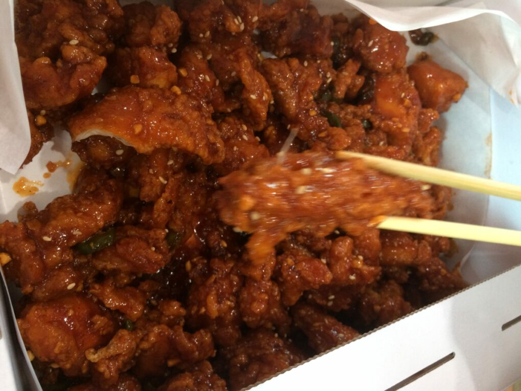 Korean fried chicken covered with sweet and spicy sauce.
