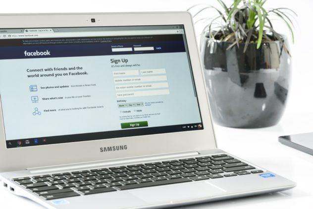 facebook login on a laptop on a white table