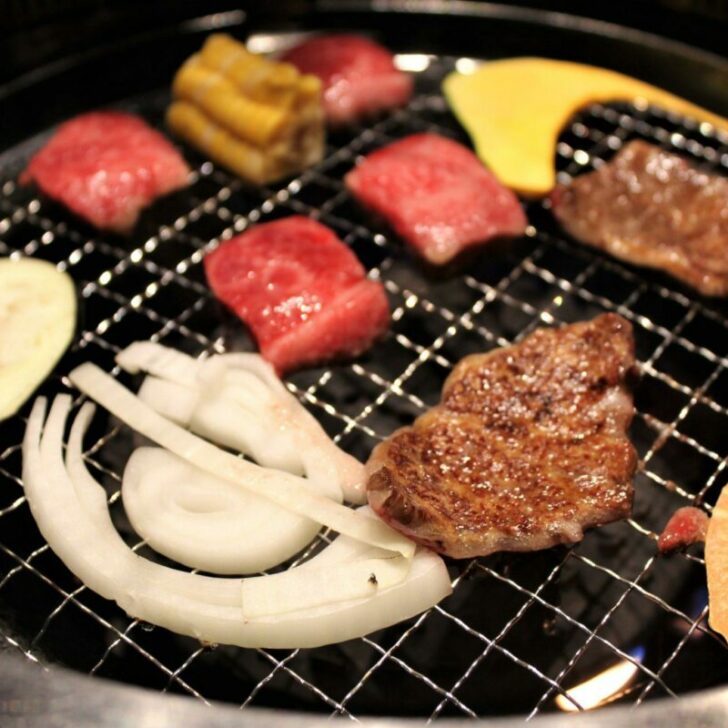 Affordable Kobe beef in Kobe shot of meat cooking on grill with vegetables