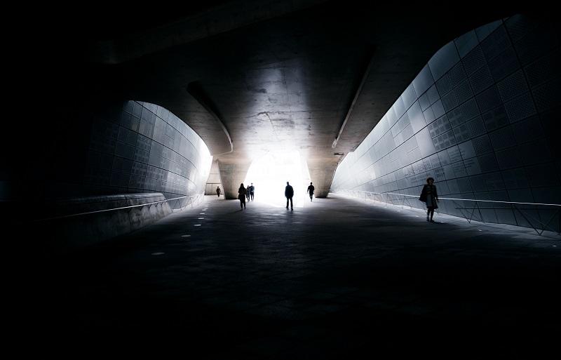 People walking in a tunnel.