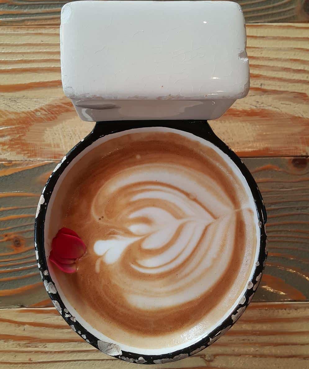 Coffee latte in a toilet shaped cup.