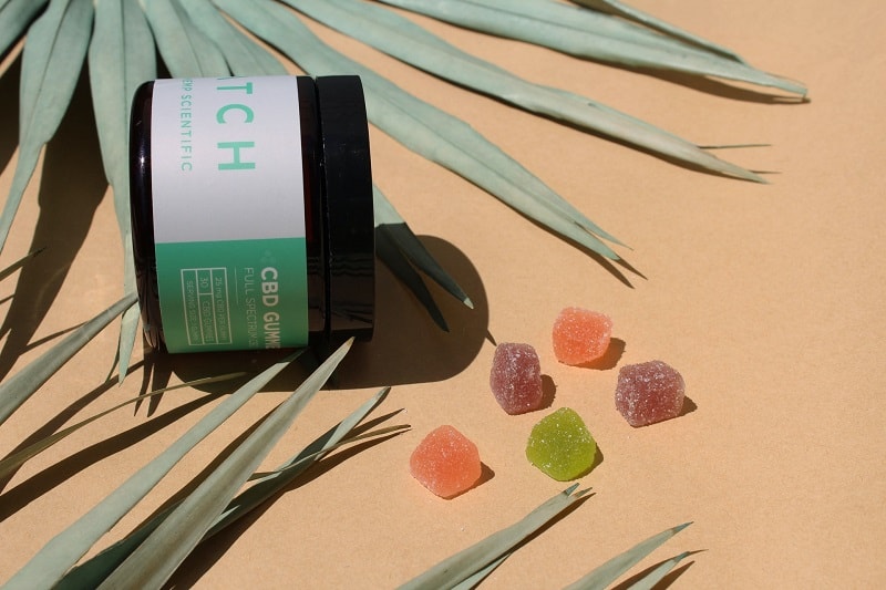 colorful CBD gummies on a flat surface.