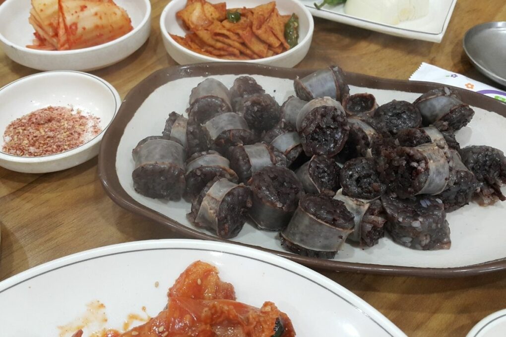 Soondae placed on a plate with other side dishes. 