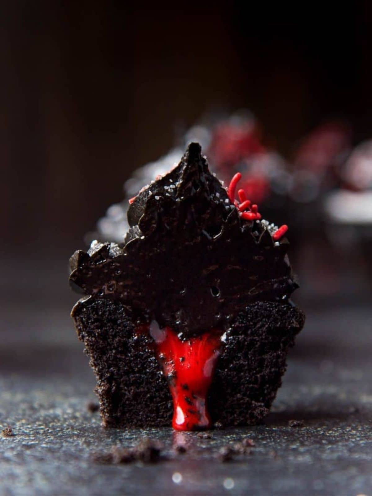 Bleeding Black Cupcakes with spooky red filling, ideal for Halloween dessert ideas.