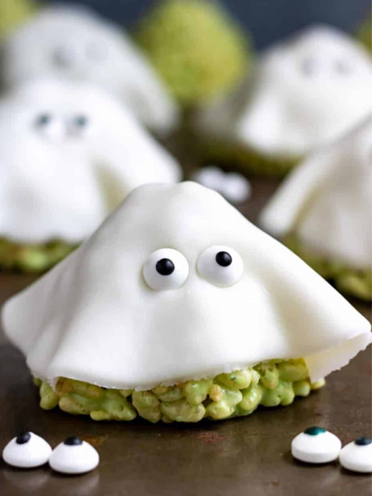 Ghost-shaped Halloween Rice Krispies Treats with spooky eyes, ideal for Halloween parties.