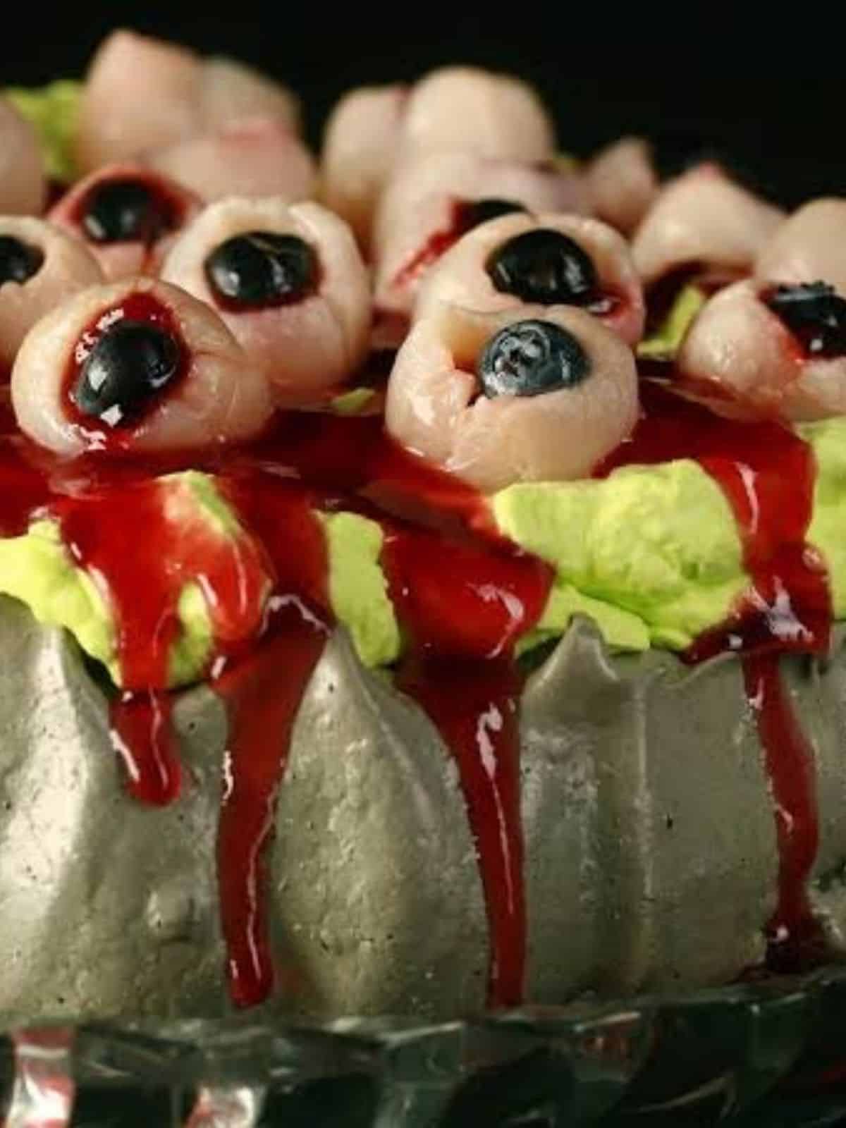 Spooky Bloody Eye Ball Halloween Pavlova with eerie red details for Halloween dessert ideas.