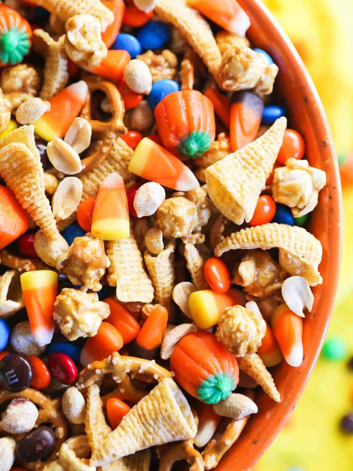 A bowl of Halloween Trail Mix with candy corn, pretzels, and chocolate treats, perfect for Halloween dessert ideas.