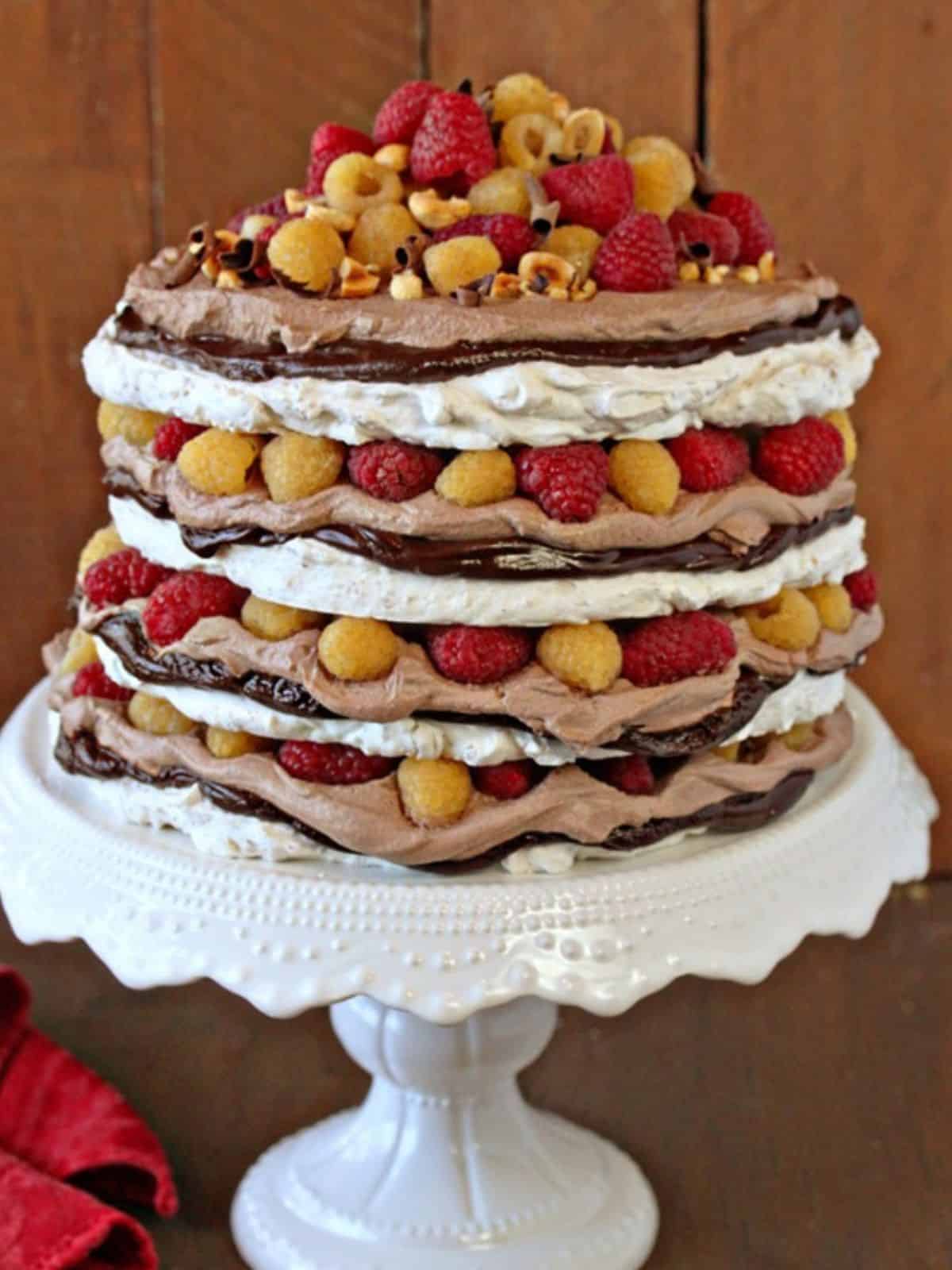 Hazelnut Meringue Cake with layers of chocolate ganache and whipped cream.