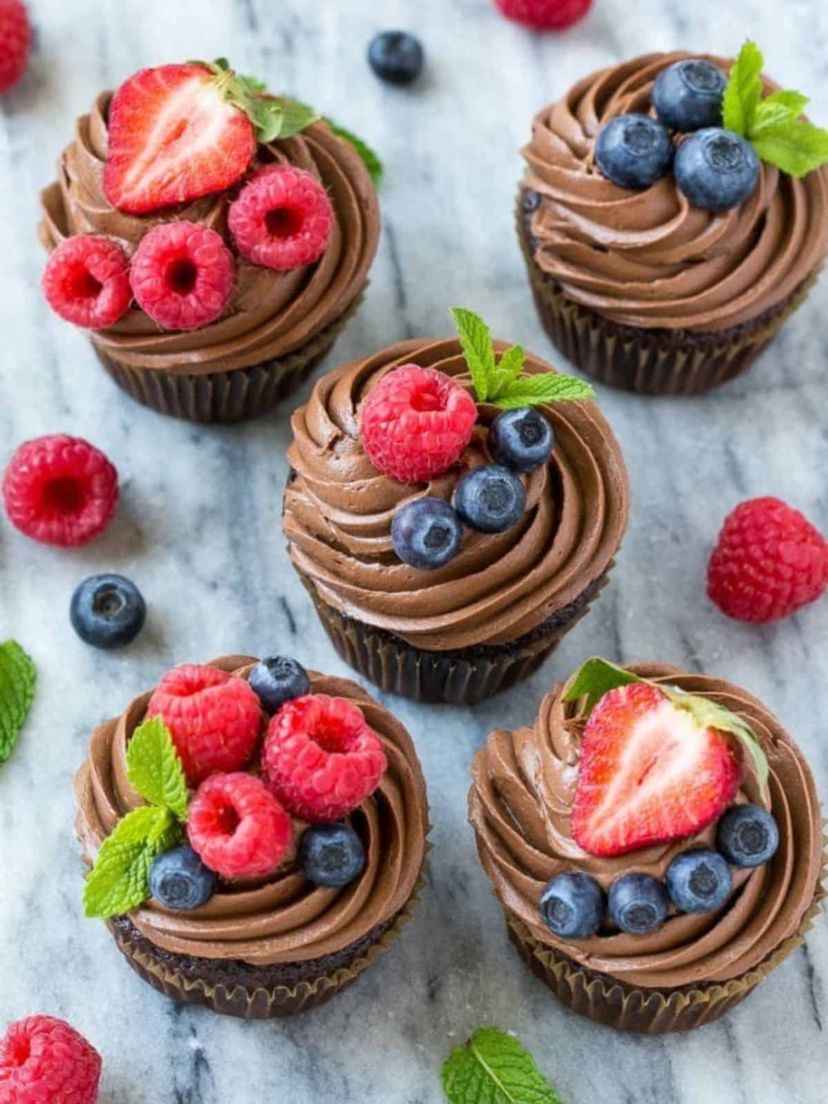 Chocolate Hazelnut Cupcakes topped with different kinds of berries. 