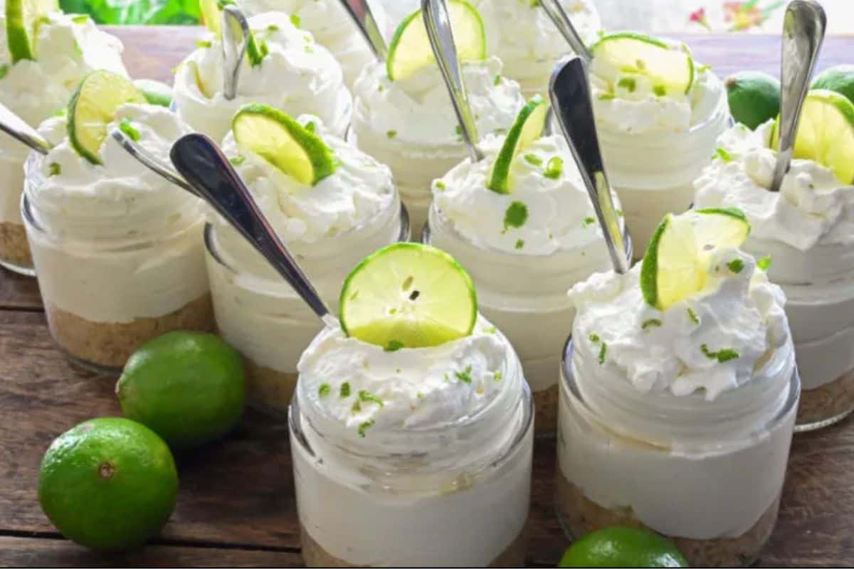 No-Bake Lime Cheesecakes in a glass, topped with a slice of lime.