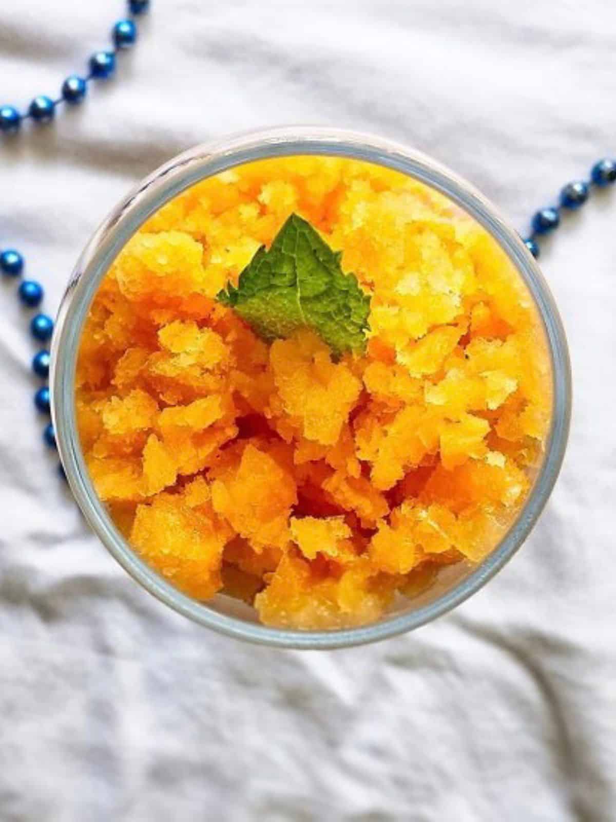 A vibrant bowl of Peach Lime Granita, a refreshing and easy-to-make lime dessert featuring juicy peaches and tangy lime.