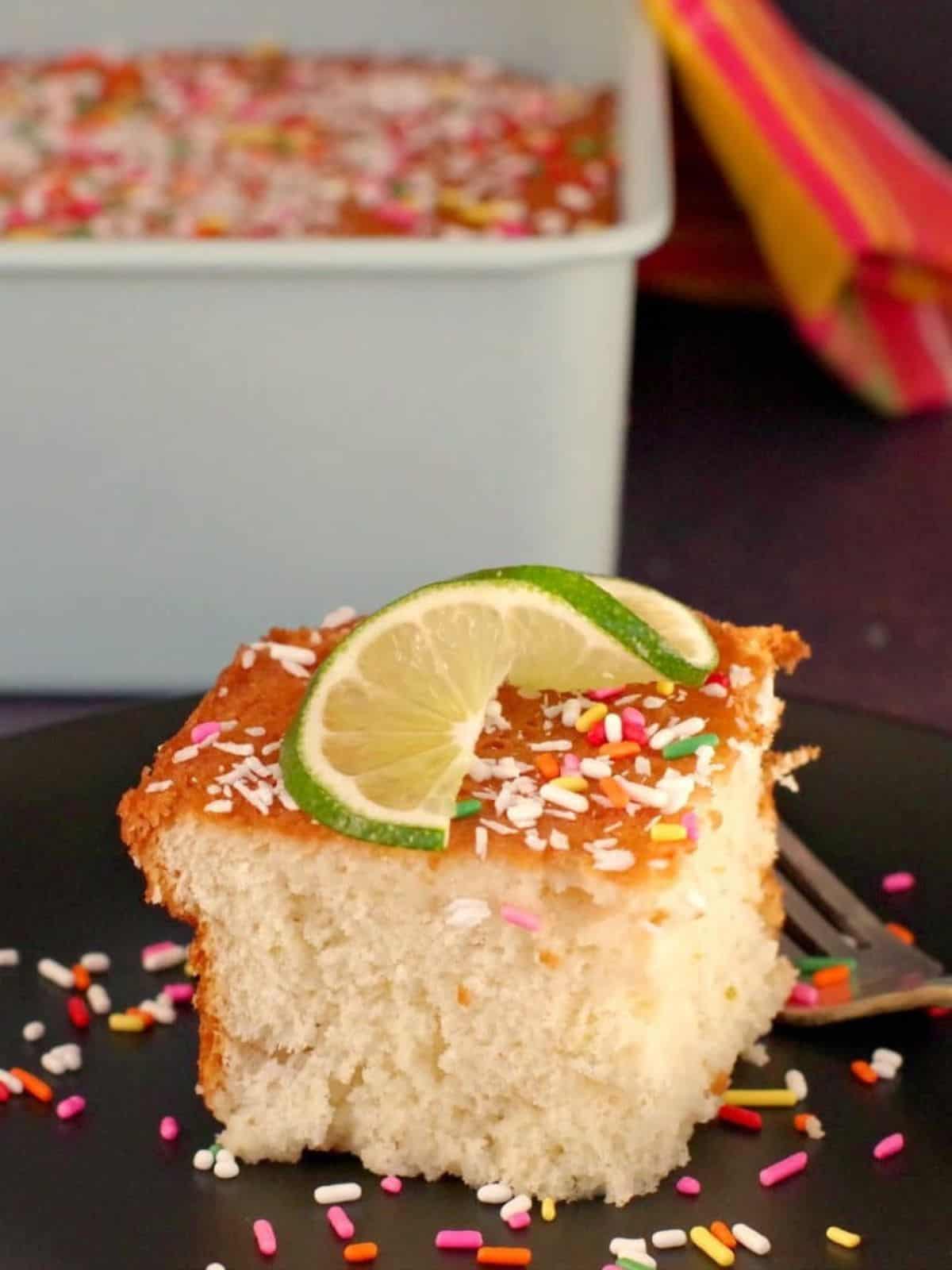 A slice of Coconut Lime Tres Leches cake, ideal for lime dessert lovers and those searching for delicious lime recipes.