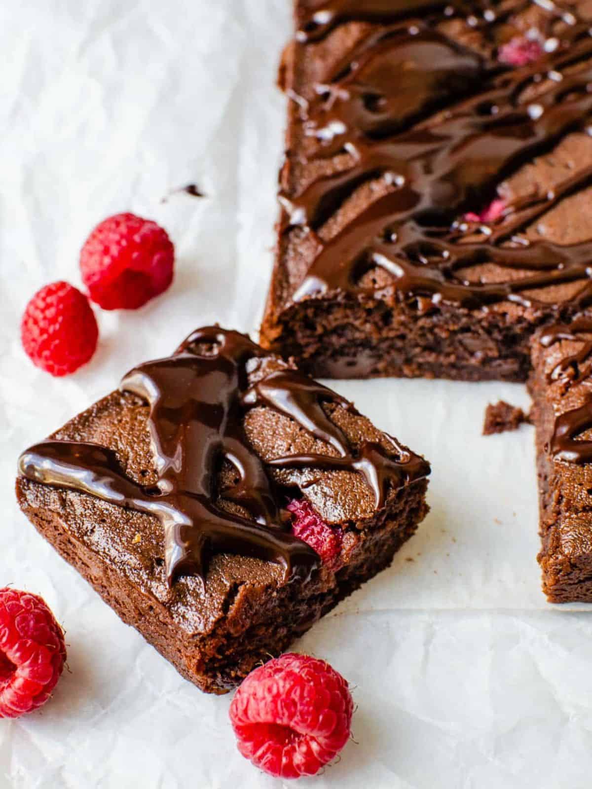 Raspberry Truffle Brownies Bars drizzled with chocolate fudge.