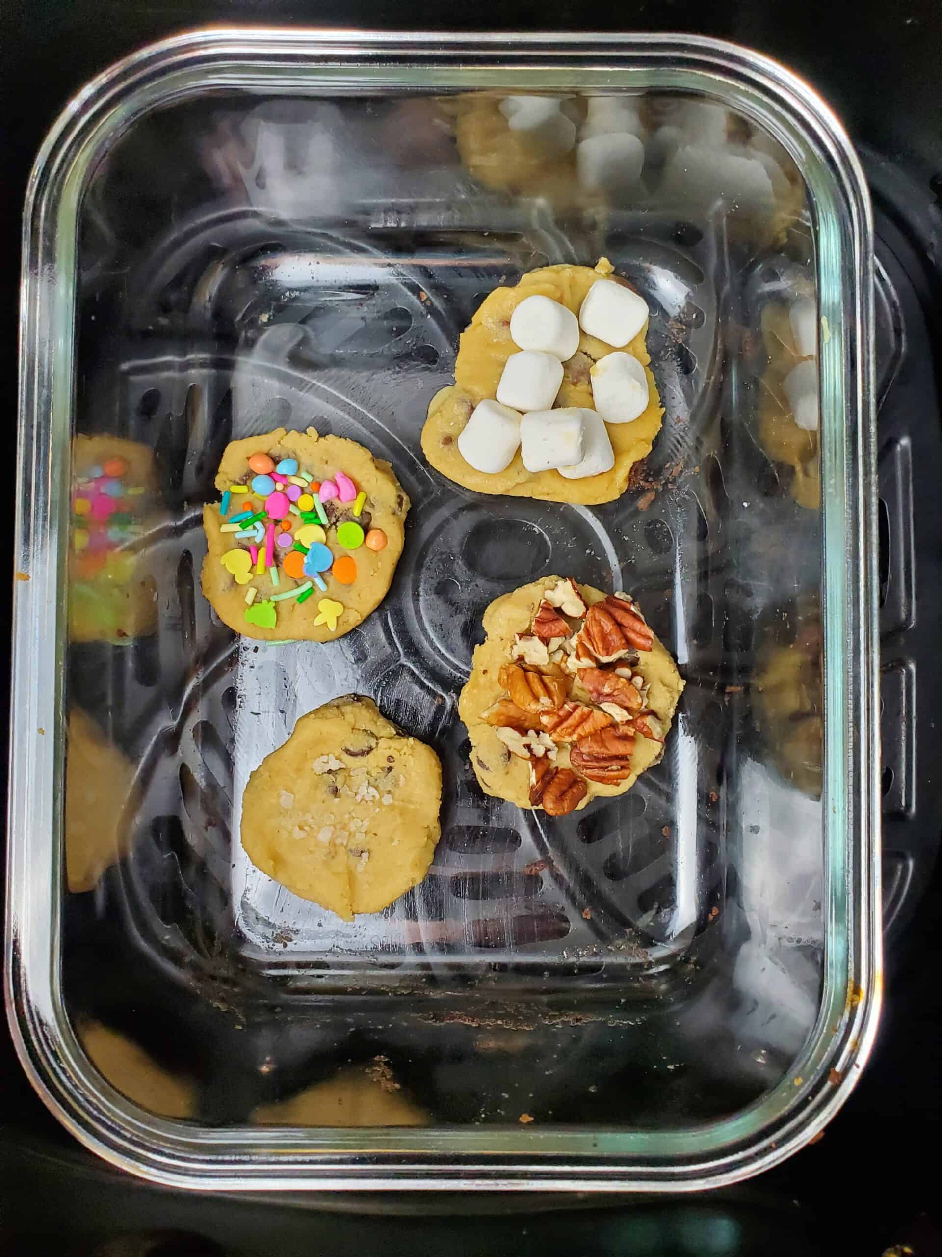 Cookies with toppings about to bake in the air fryer.
