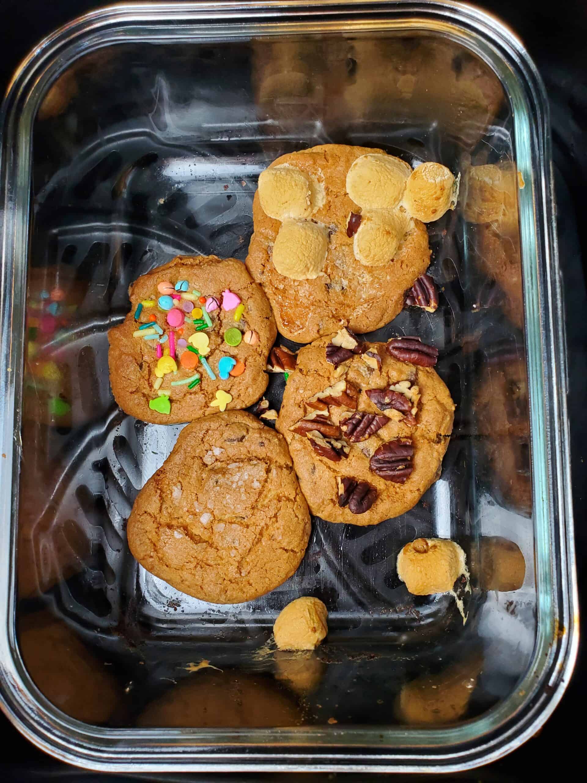 Baked cookies with toppings in a glass container in the air fryer.
