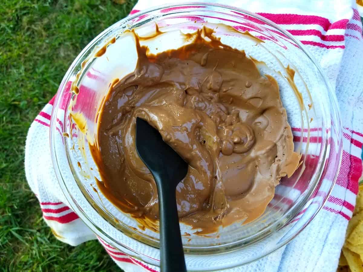 melted chocolate chips in a heat-proof bowl with rubber spatula