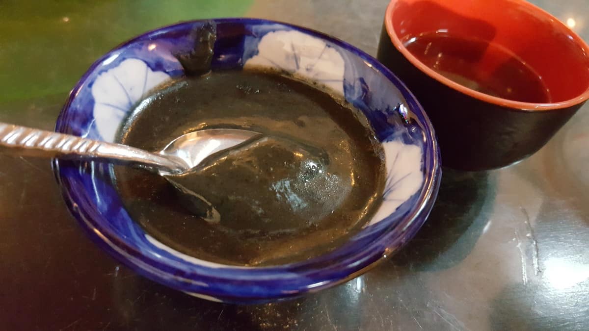 Vietnamese black sesame soup with a spoon in it.