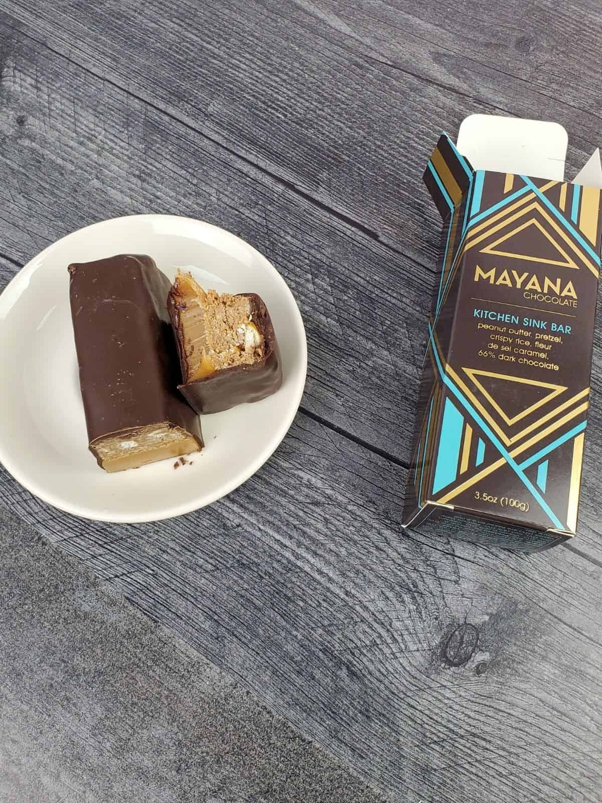 cross section of a mayana chocolate brand candy bar on a white plate.