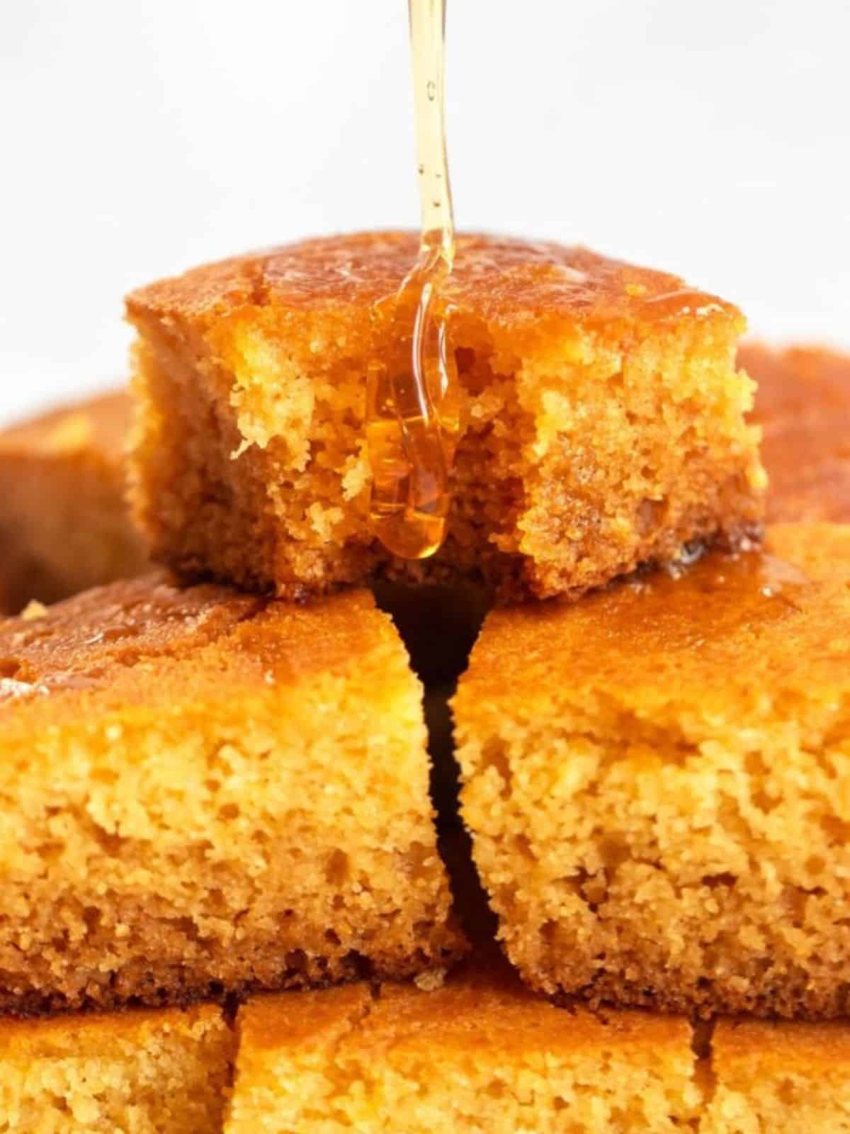 golden brown buttermilk cornbread drizzled with syrup.