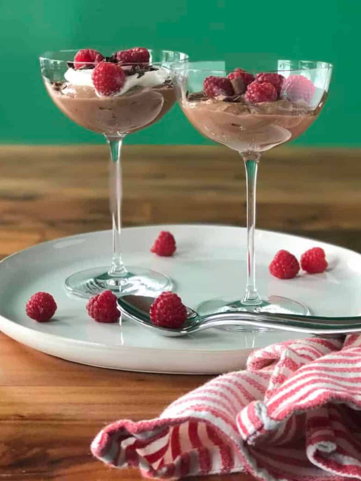 Rich and smooth Chocolate Ricotta Pudding topped with Raspberries in champagne saucers