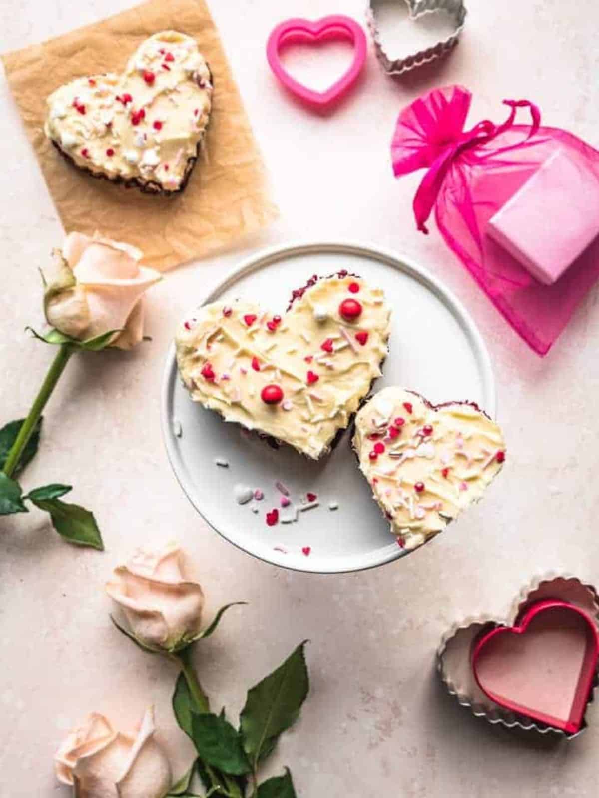 Heart-Shaped Red Velvet Blondies topped with a luscious Cream Cheese Frosting and Valentine sprinkles