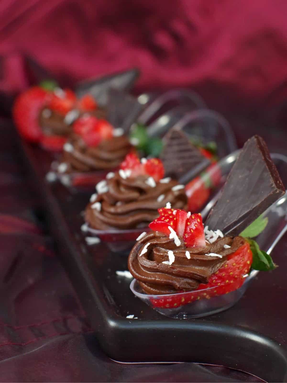 Divine No-bake Chocolate Avocado Mousse topped with Strawberries in dainty spoons 