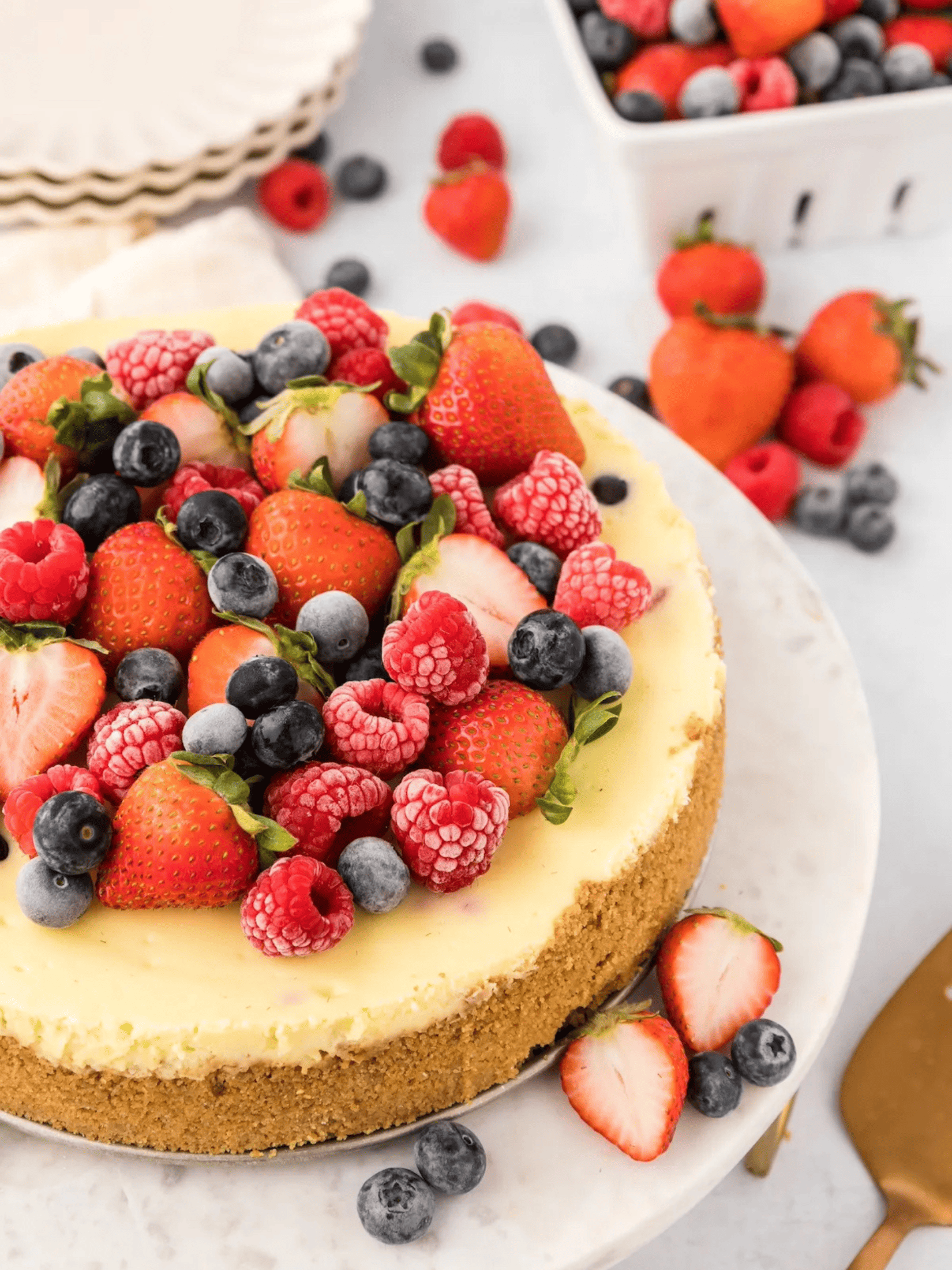 a decadent berry cheesecake, topped with a vibrant assortment of fresh berries.