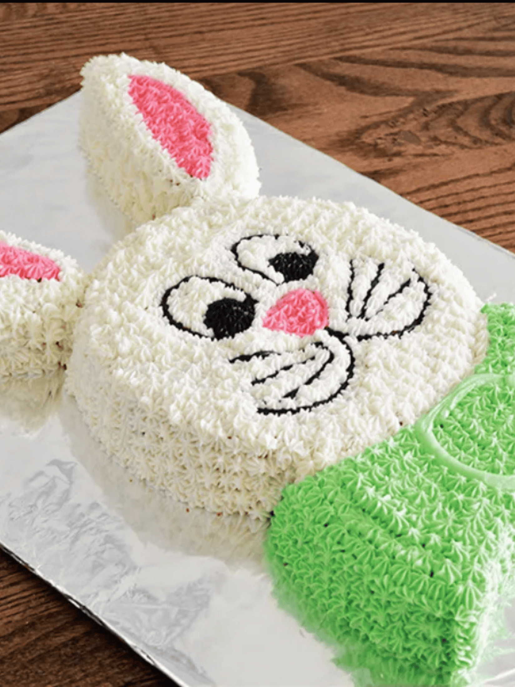 a decorative bunny-shaped cake with pastel-colored frosting.