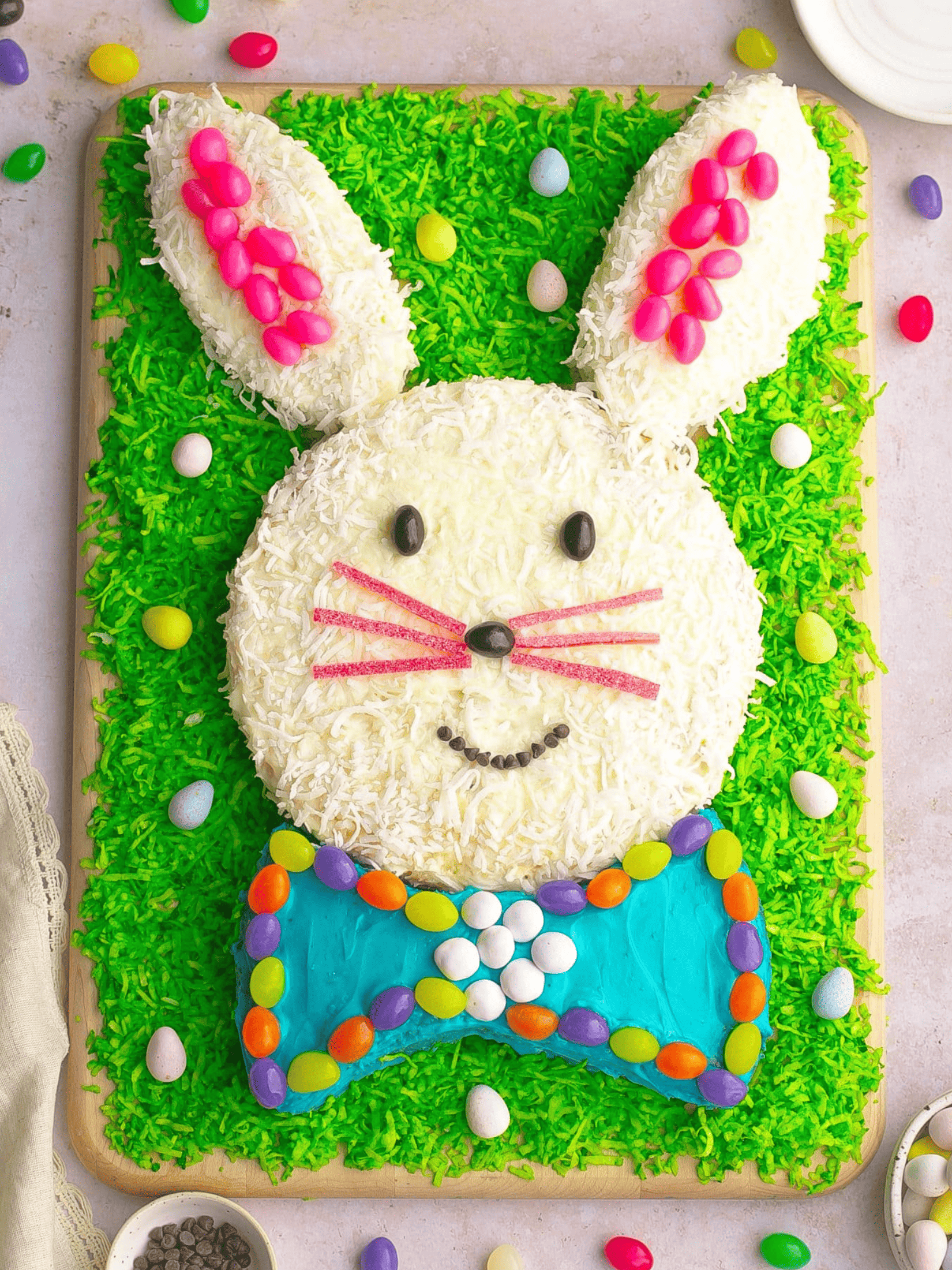 delicious coconut Easter bunny cake surrounded by pastel-colored Easter eggs.