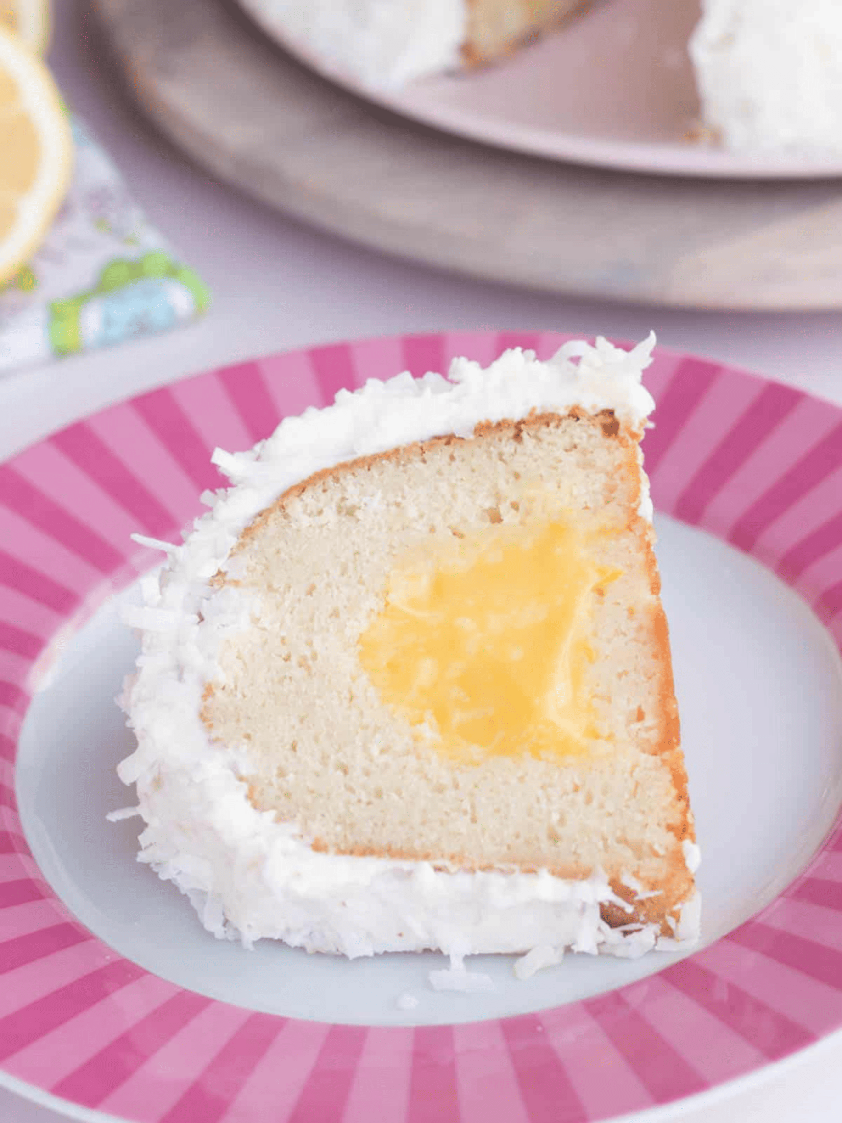 a slice of moist coconut lemon bundt cake on a plate.