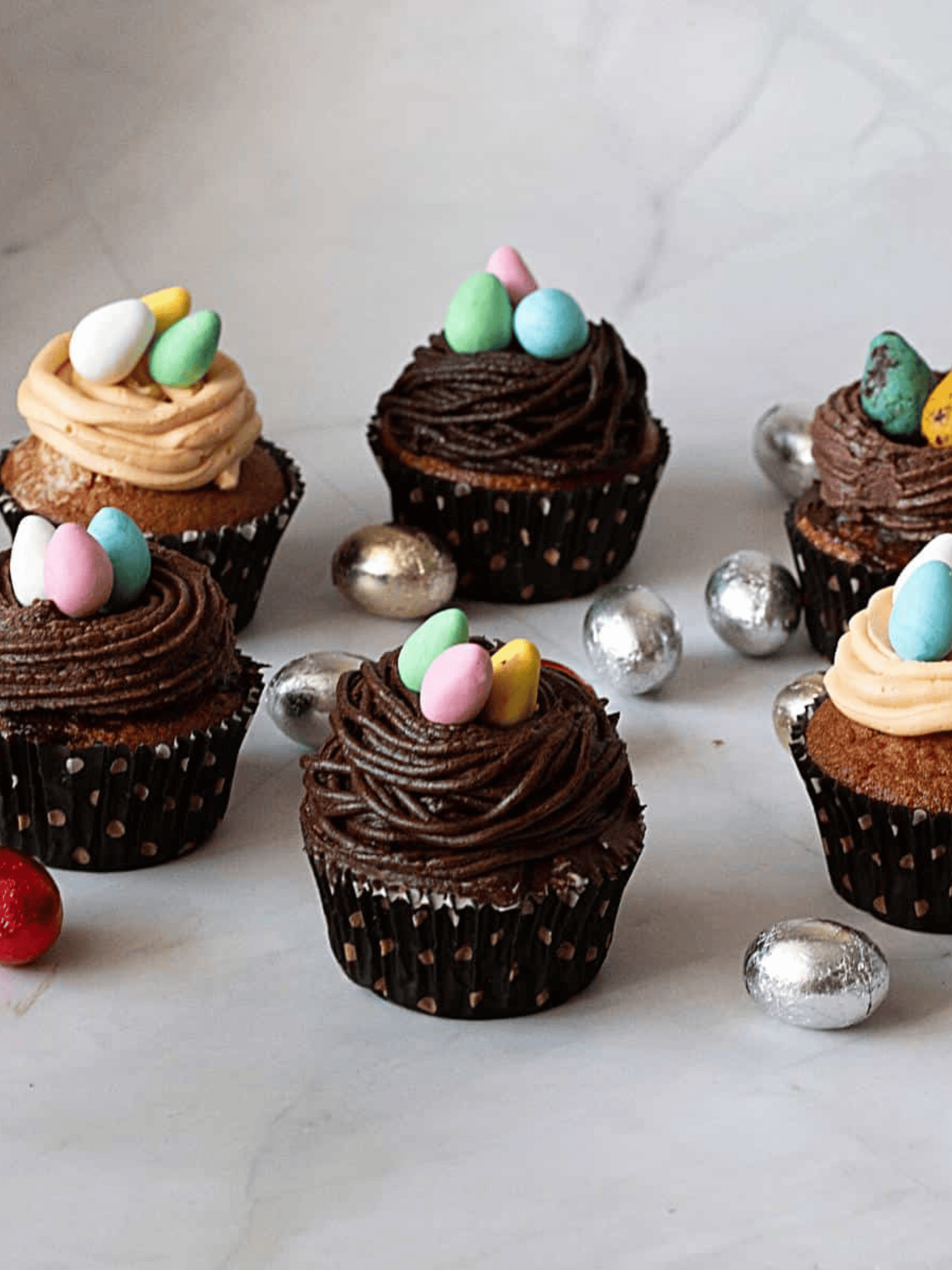 delicious Easter chocolate bird's nest cupcakes topped with colorful candy eggs.