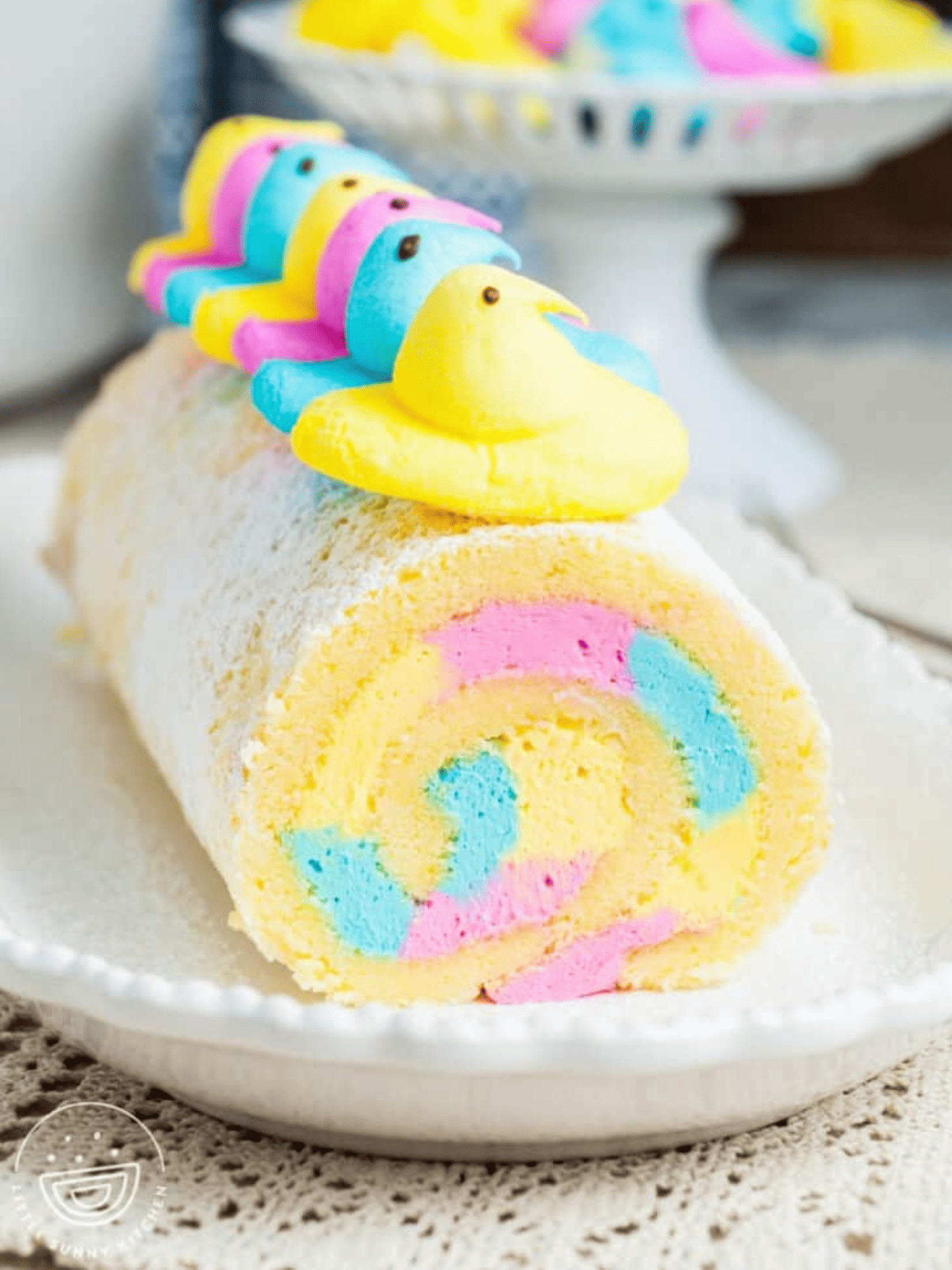 delicious Easter cake roll with pastel-colored frosting, adorned with festive decorations.