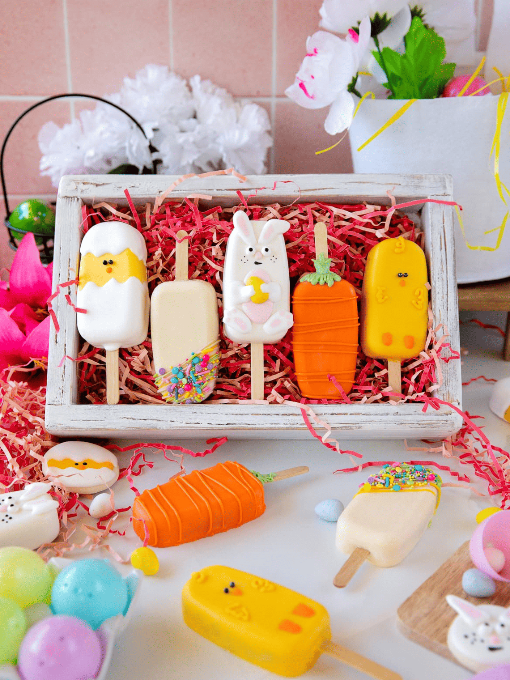 colorful Easter-themed cakesicles with decorative frosting.
