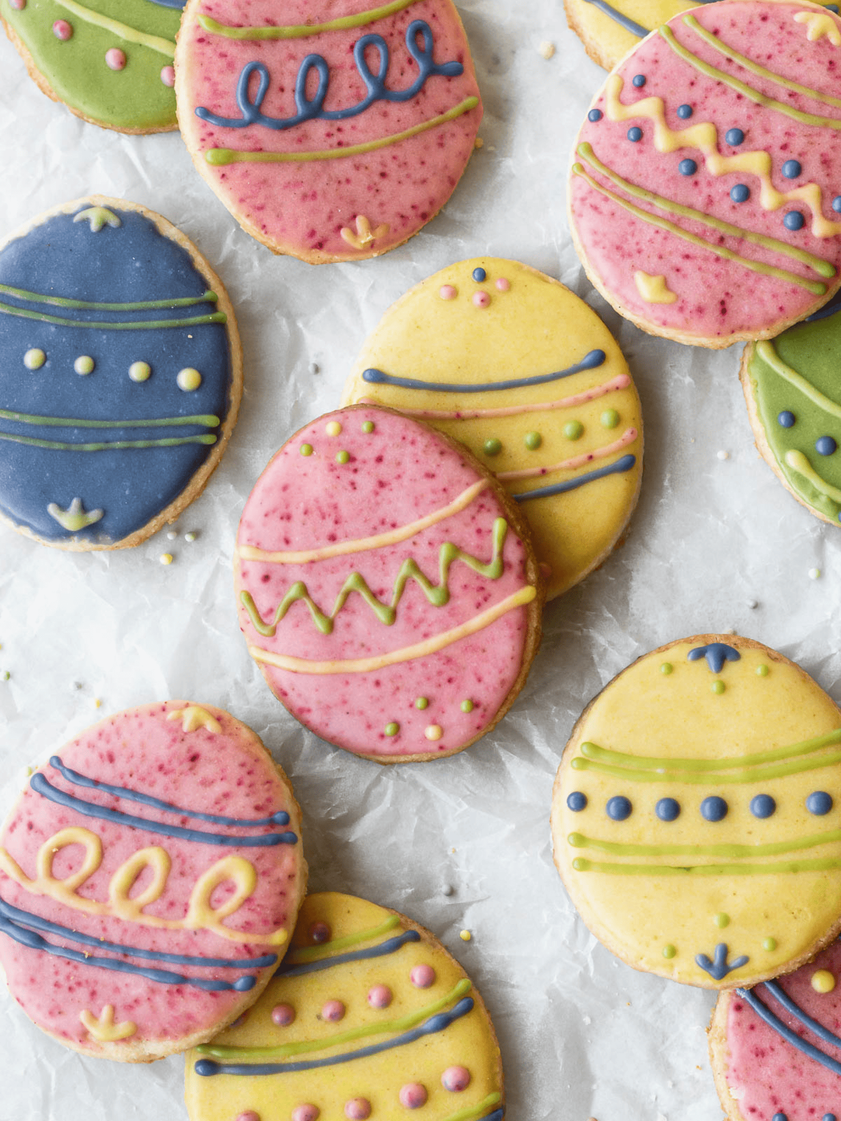 delicious Easter egg-shaped sugar cookies beautifully decorated with vibrant colored icing.