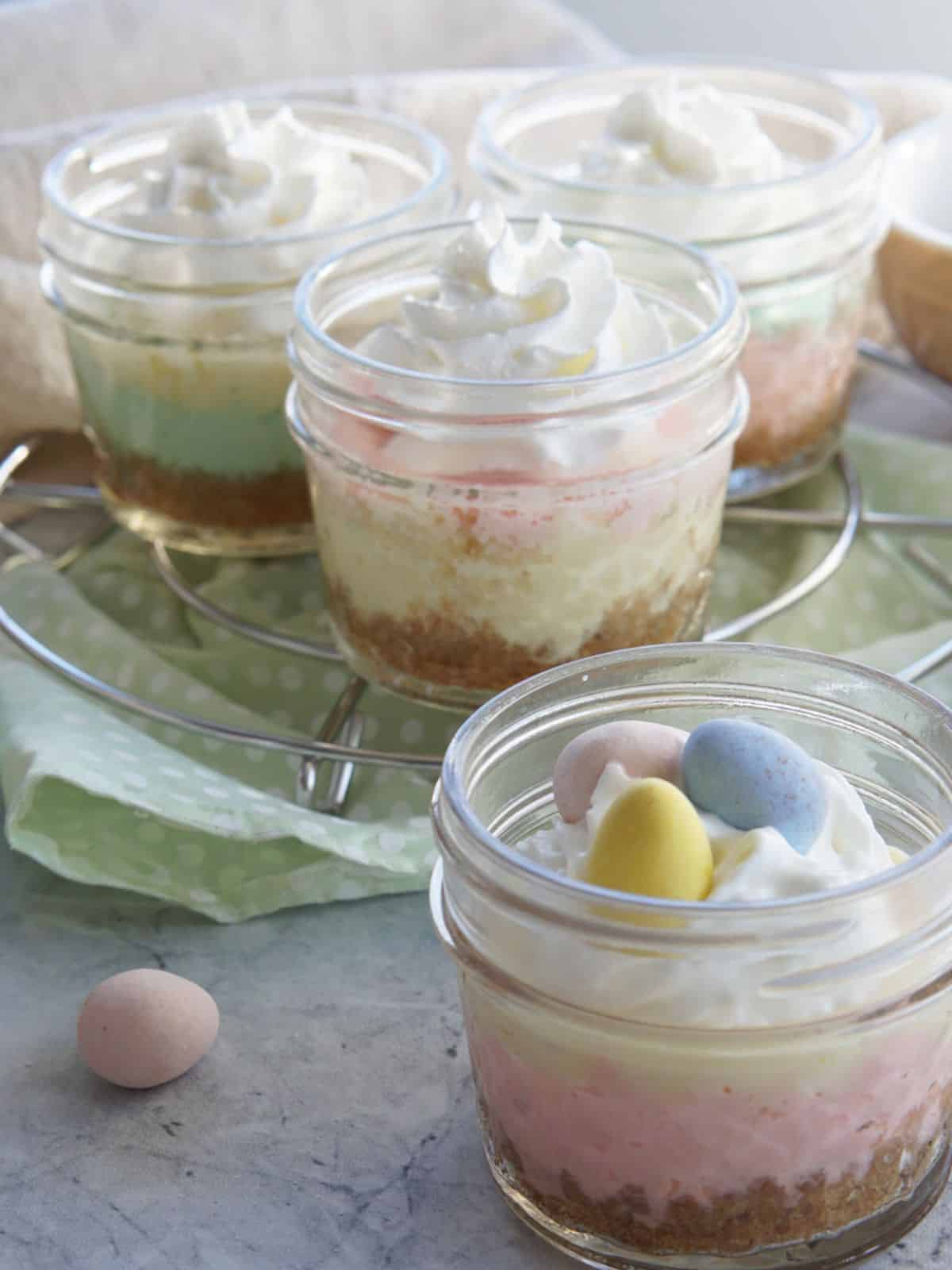 a delightful Instant Pot Easter cheesecake in a transparent glass mug.