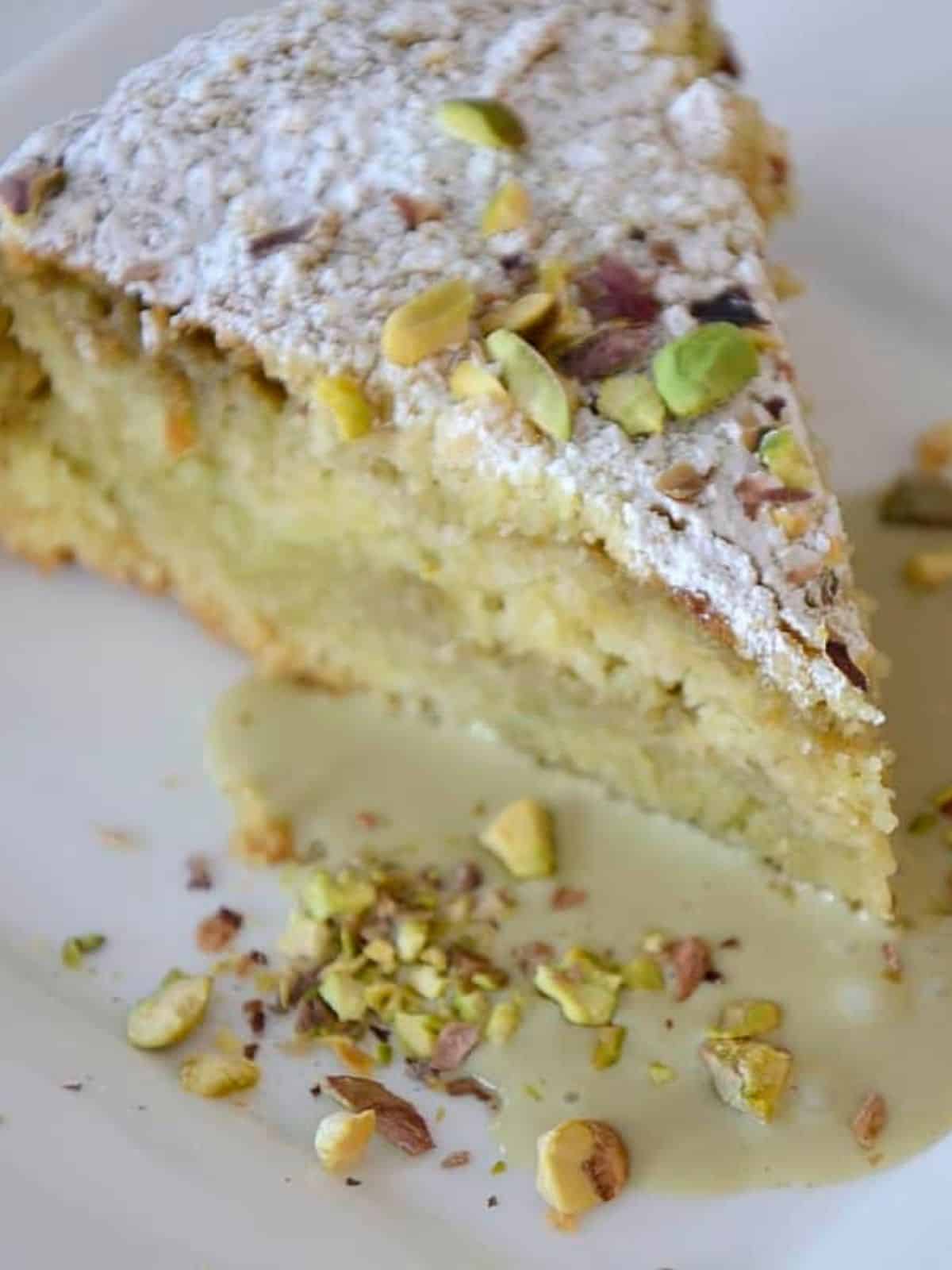 a delectable slice of pistachio cheesecake, topped with chopped pistachios and served on a delicate plate.