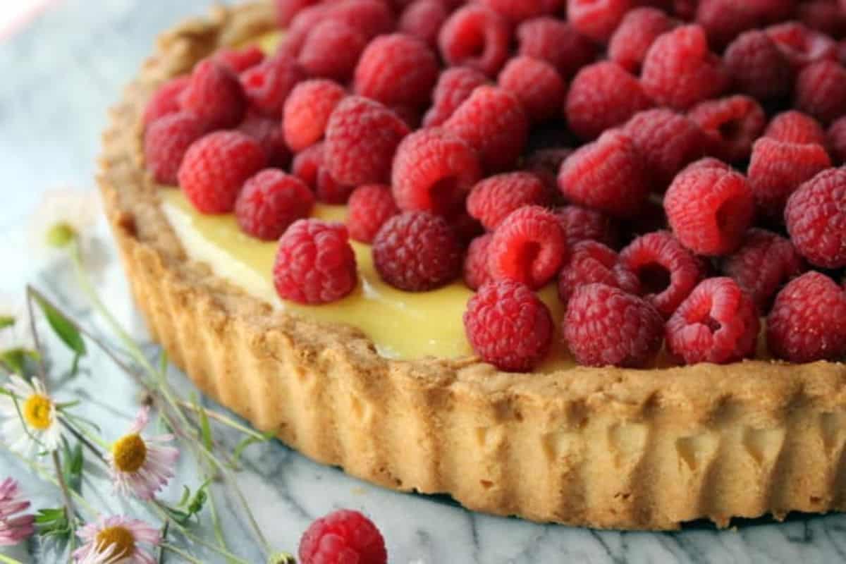 luscious lemon tart made with lemon curd, topped with raspberries.