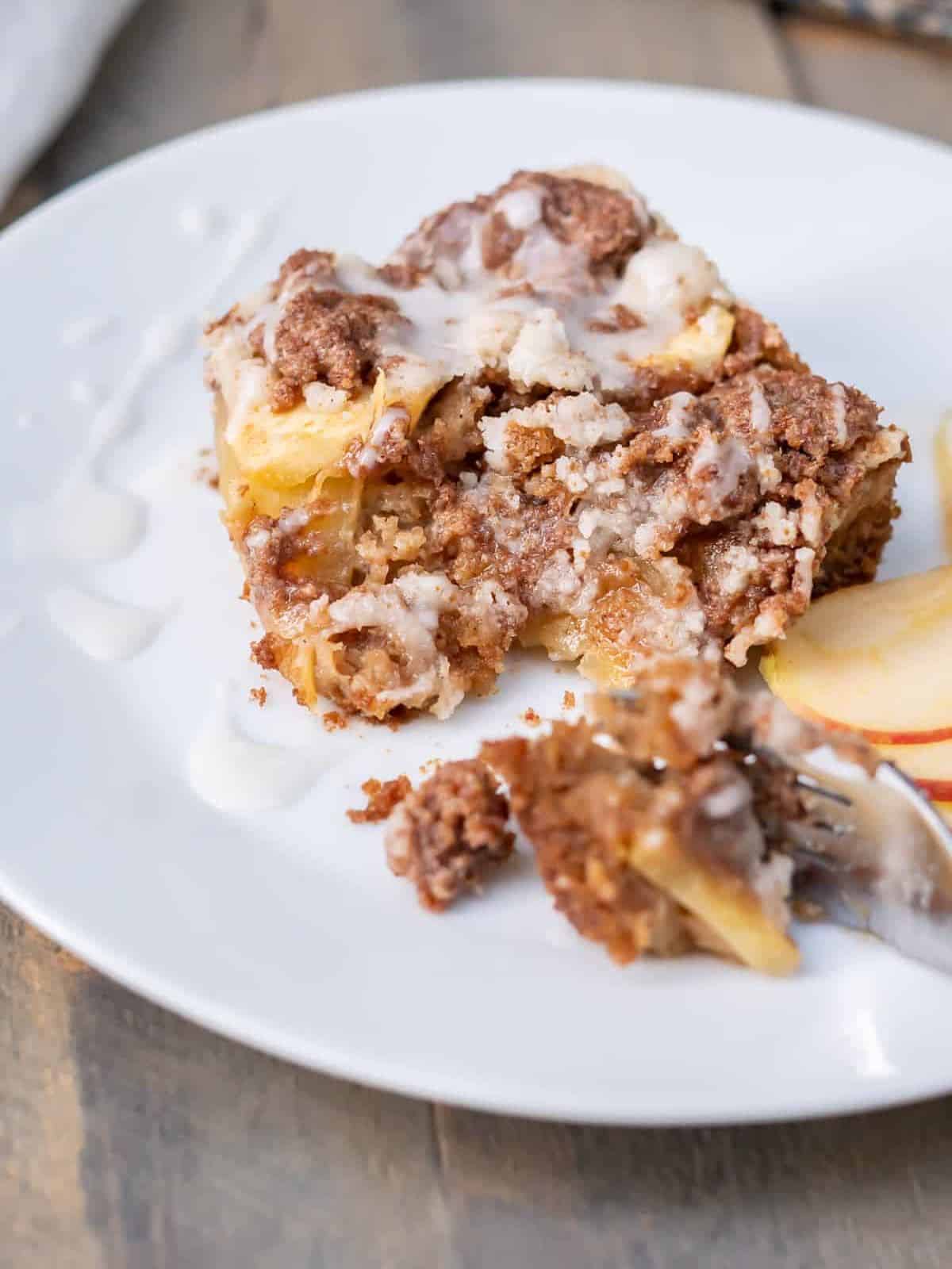a slice of gluten free apple coffee cake on a plate.