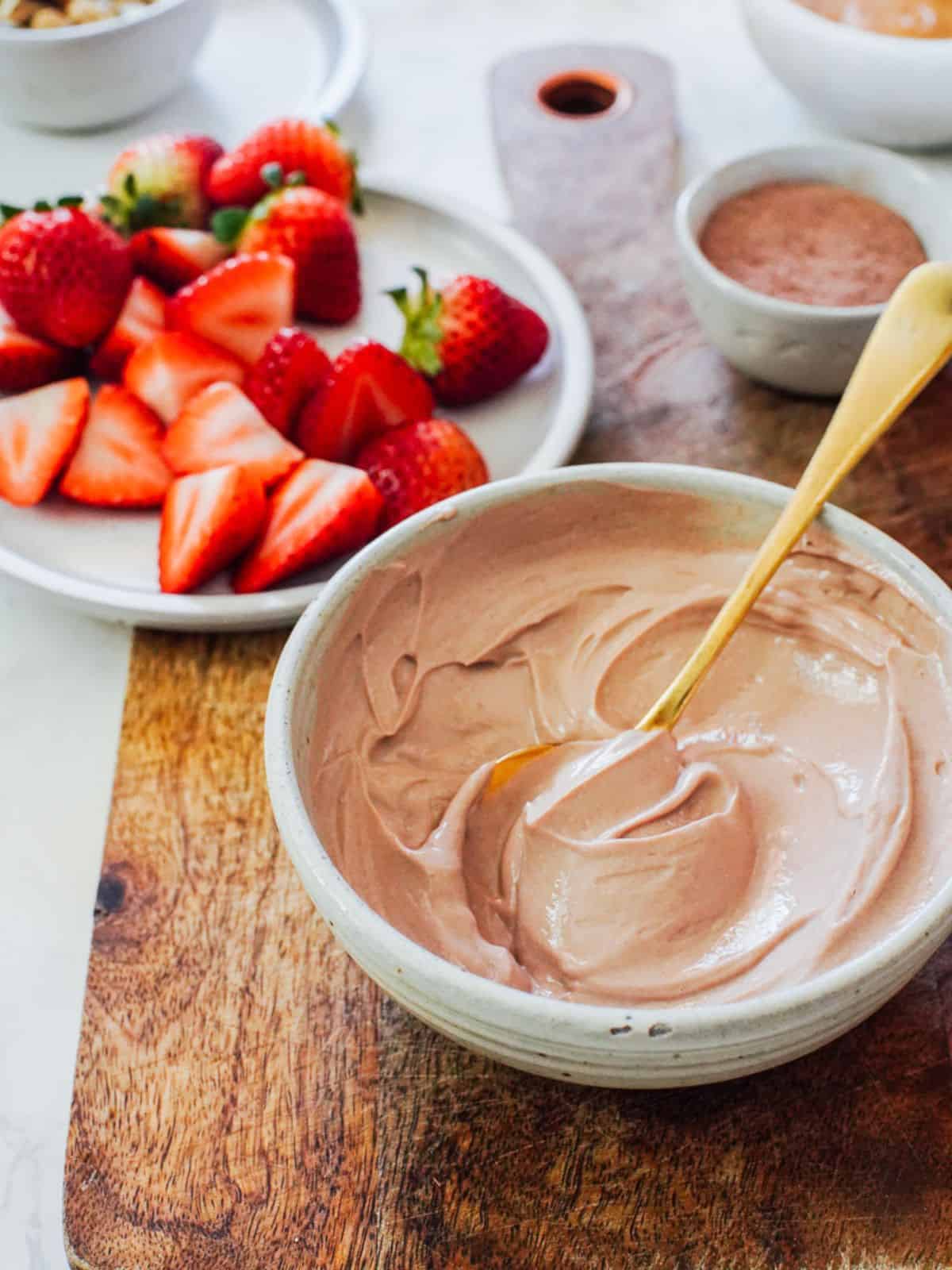 a bowl of homemade chocolate yogurt with fresh strawberries.