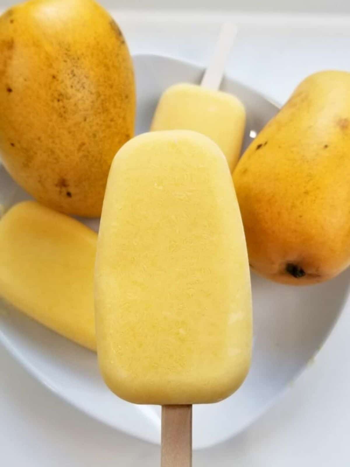 creamy mango popsicles made with mango chunks, coconut milk, and low histamine sweetener.