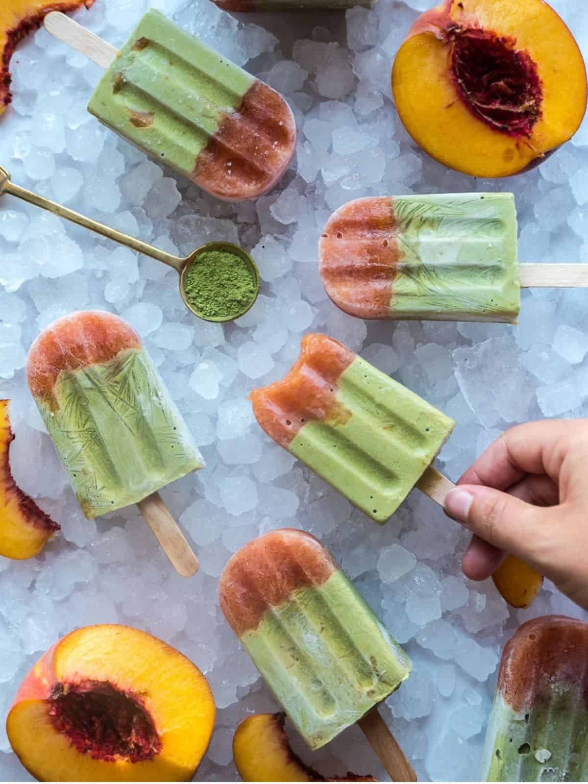 creamy and refreshing matcha and peach popsicles made with peach, coconut milk, avocado, matcha, and maple syrup.