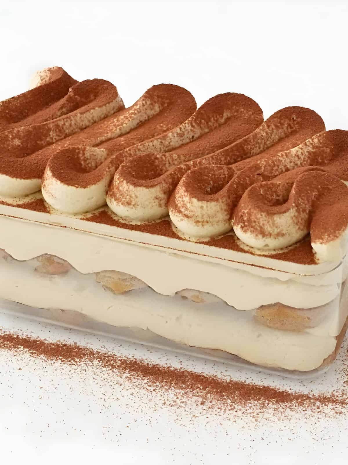 caramel coffee dessert box made with layers of delicious coffee cream sandwiched between coffee-dipped biscuits, topped with caramel latte-flavored whipped cream.