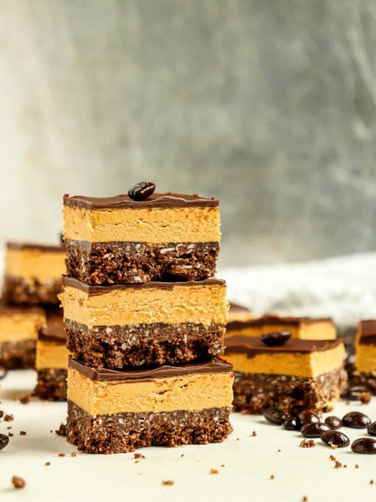 Canadian coffee nanaimo bar treats featuring a silky chocolate top and the coconut graham cracker crust with coffee-flavored custard icing.