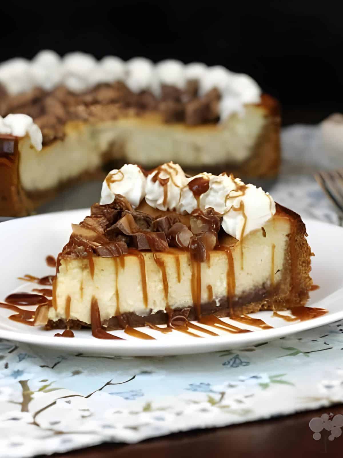 a slice of velvety Kahlua toffee cheesecake topped with caramel, toffee candy, and Kahlua whipped cream.