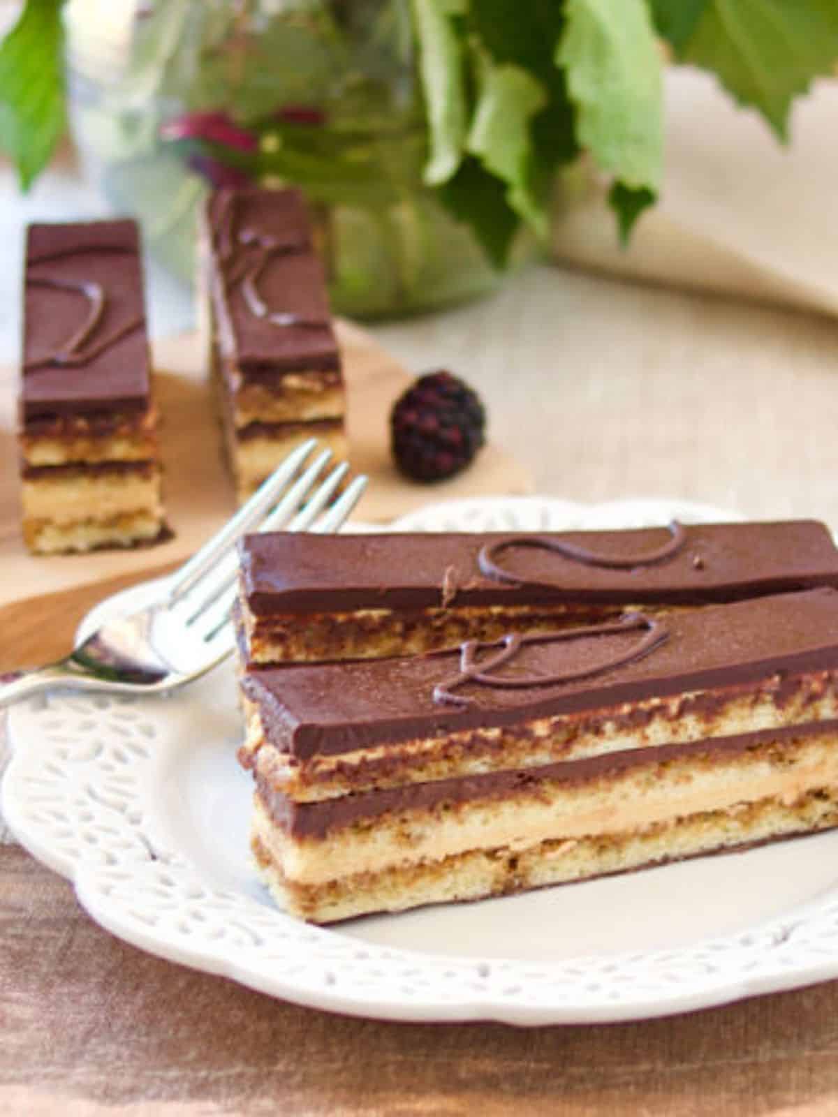 scrumptious Opera cake packed with coffee flavors, layered with Joconde sponge, coffee-flavored French buttercream, coffee syrup, melted chocolate, and opera glaze.