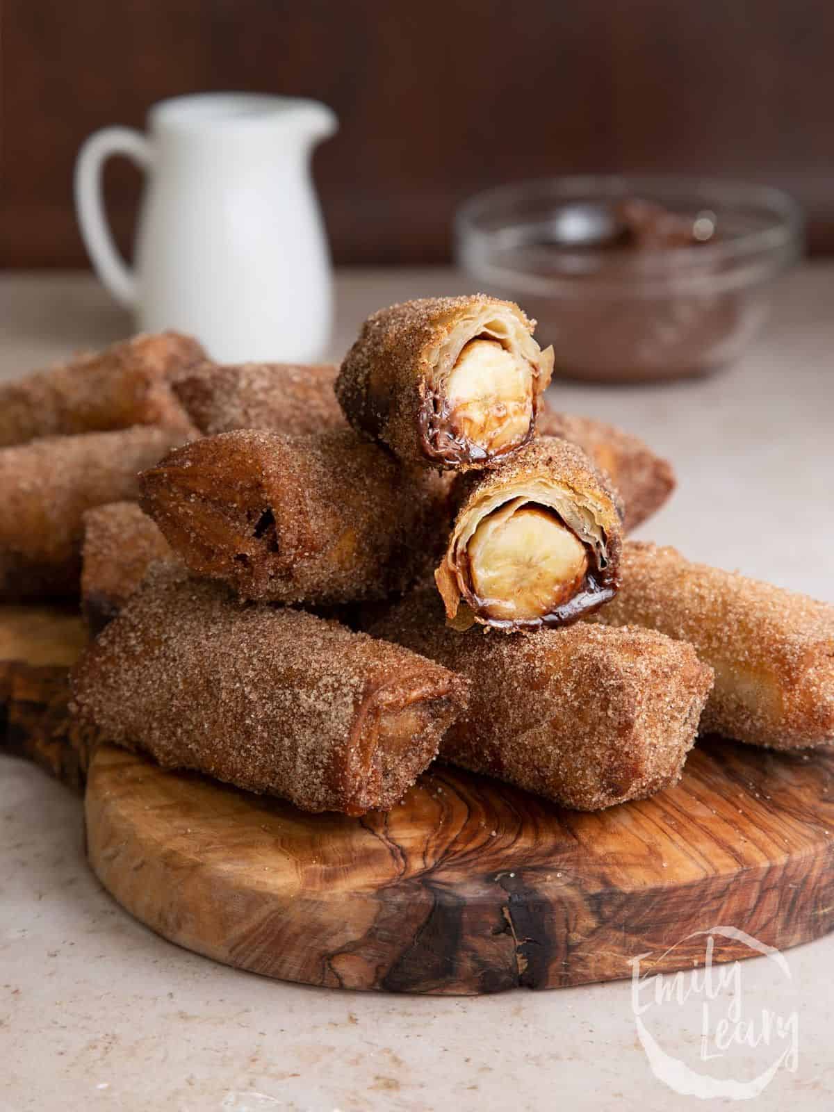 banana chocolate spring rolls made with sweet banana in a syrupy pool of warm Nutella, encased in crisp pastry, and dusted with cinnamon sugar.