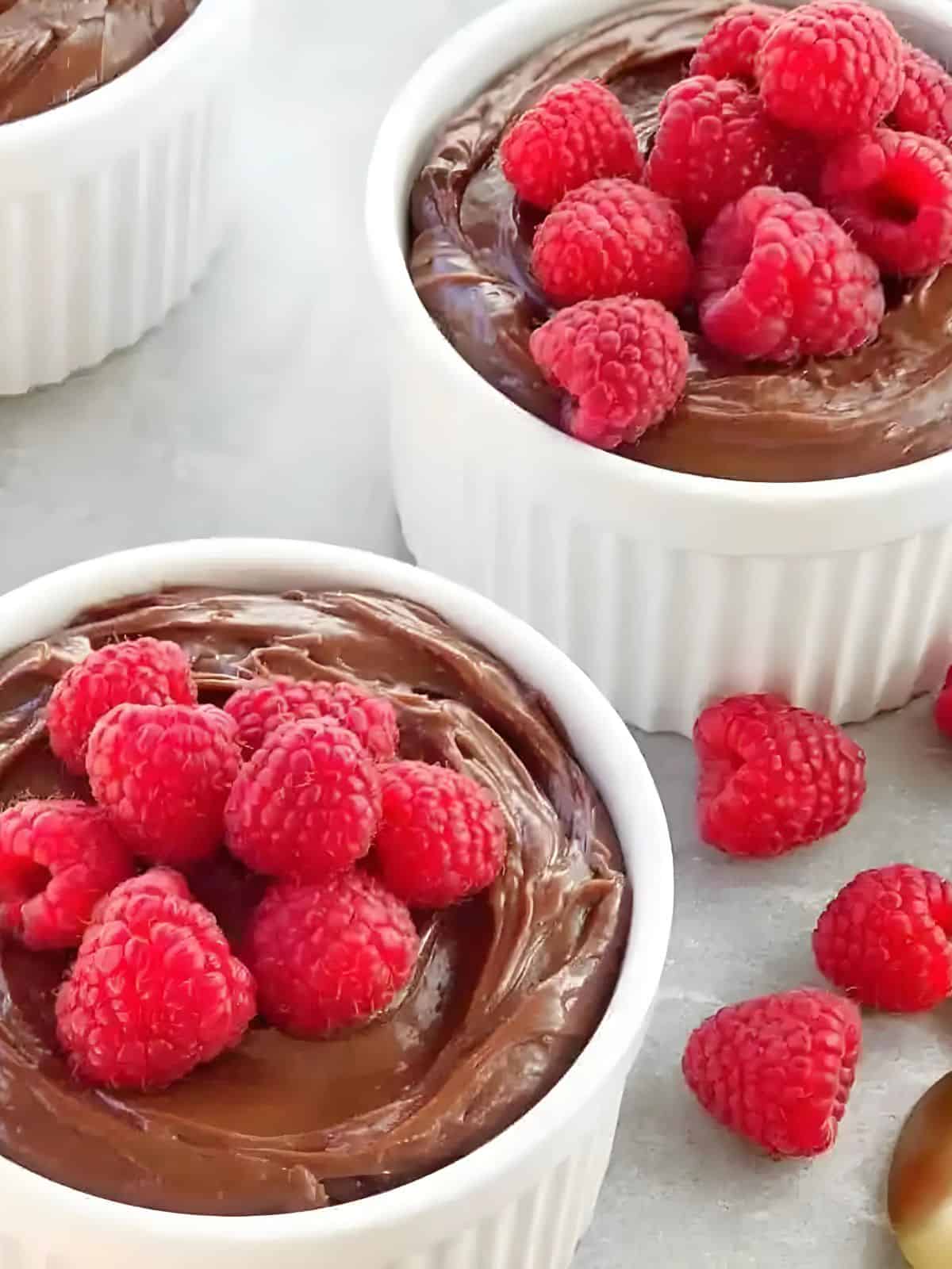 mascarpone Nutella cream in a mug, topped with fresh raspberries.