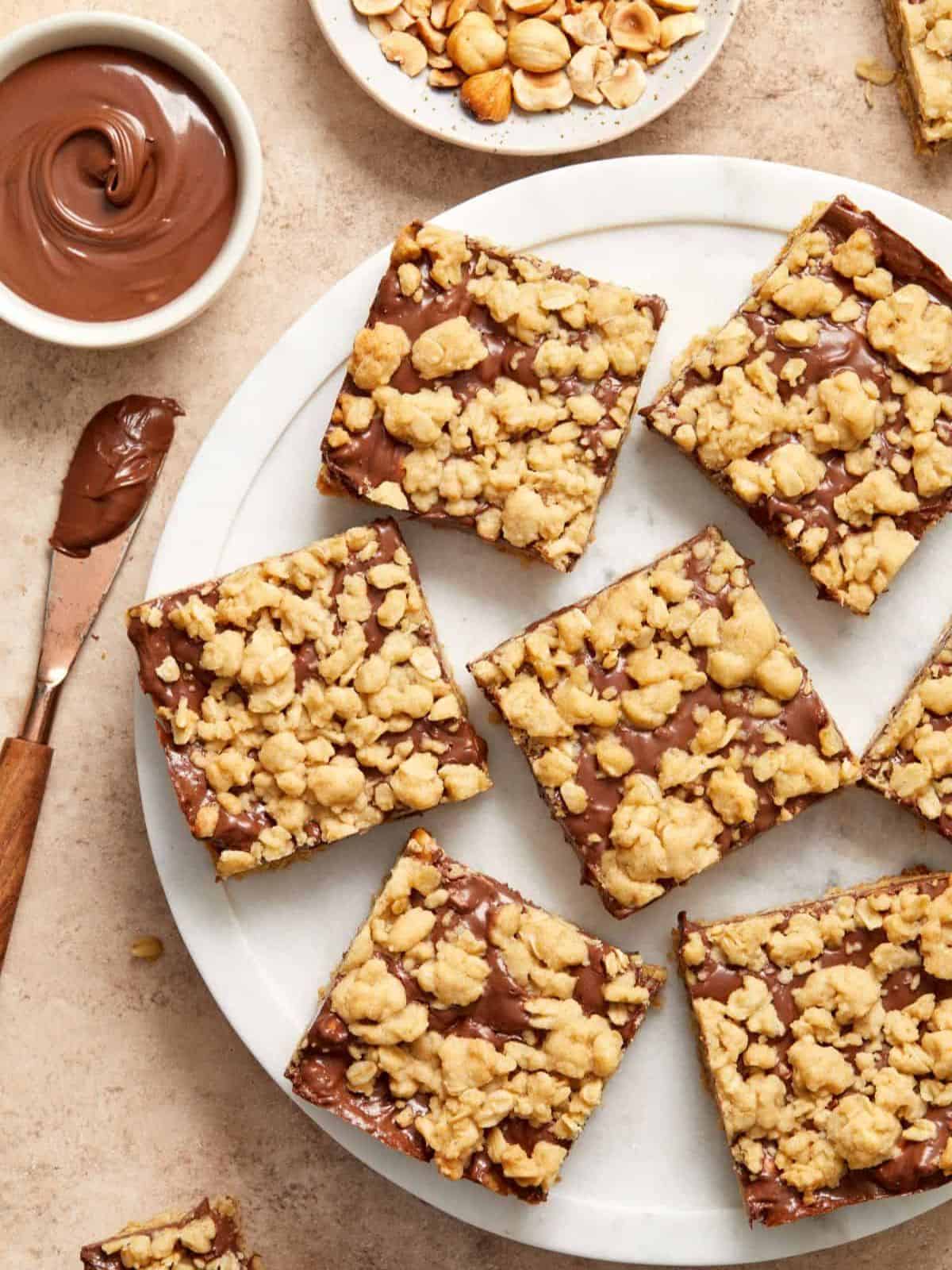 Nutella oatmeal bars featuring a crisp base, Nutella center, and a crispy crumble topping.